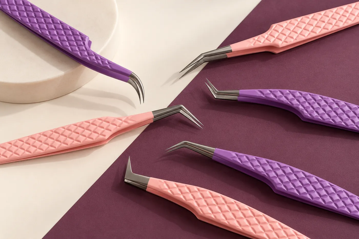 Pink and purple textured tweezers on an ivory and plum background