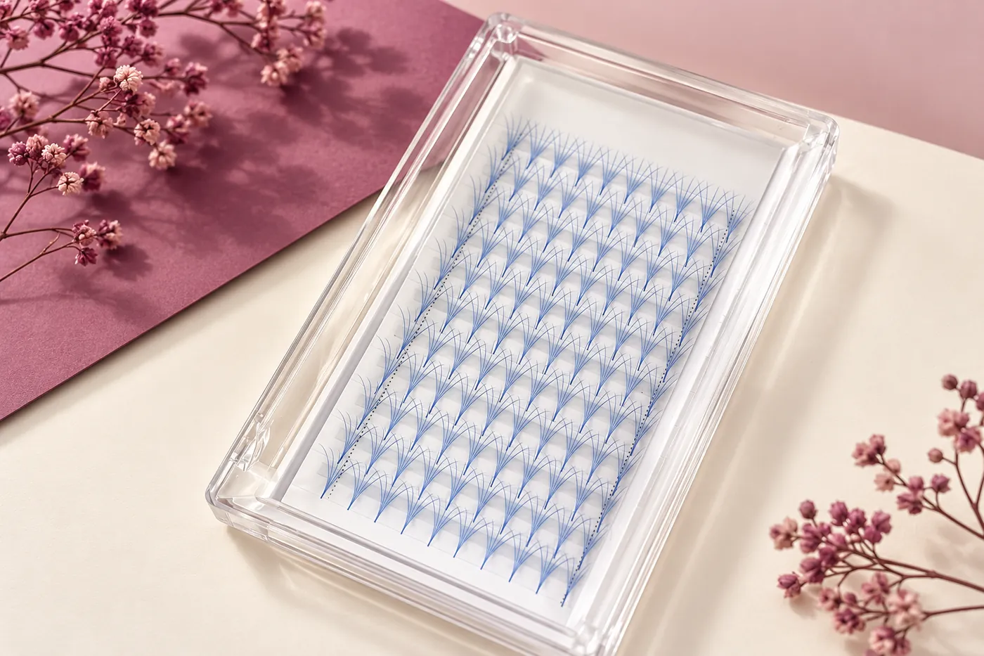Clear tray of separate light-blue premade fans on a white insert