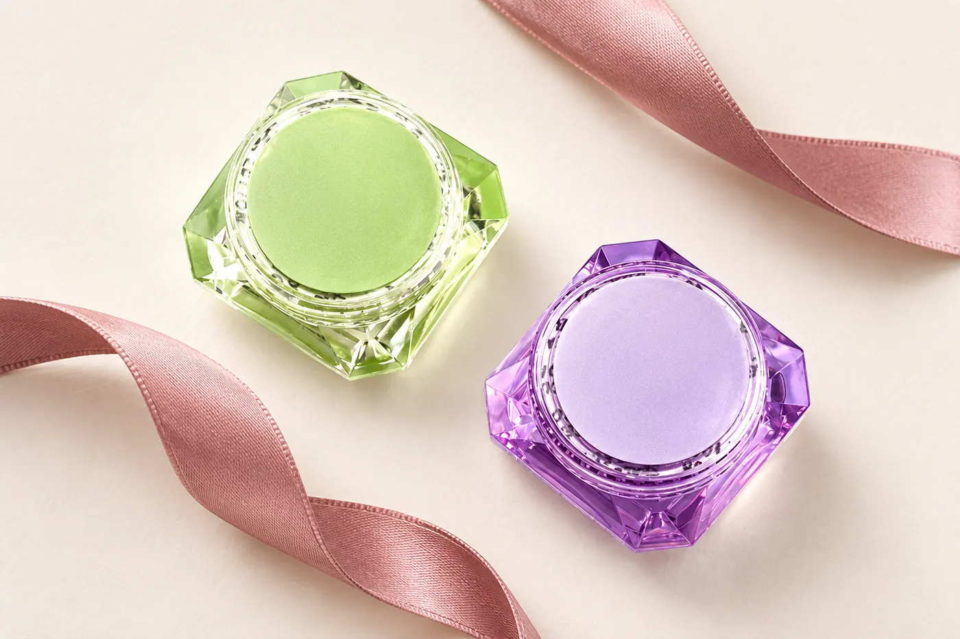 Closed green and purple faceted remover jars viewed from above